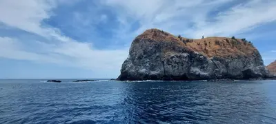 a small island in the ocean on a cloudy day at Pequeno Paraiso - New Studio, 10min walk to Potrero beach, tranquil - Unit D in Potrero