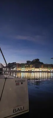 a boat sitting in the water at night at Pequeno Paraiso - New Studio, 10min walk to Potrero beach, tranquil - Unit D in Potrero