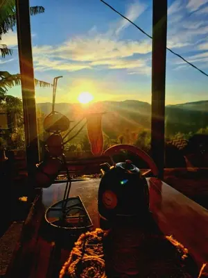 a view of the sunset from a room with a table at Glamping Los tucanes in San José