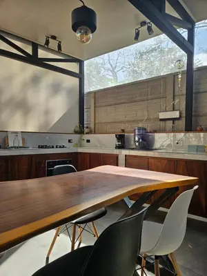a large kitchen with a wooden table and chairs at Mystica Playa Avellanas in Playa Avellana