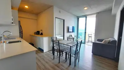 a kitchen and living room with a table and chairs at Sabana Chic in Hatillo
