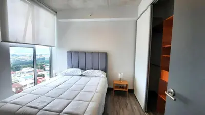 a bedroom with a large bed with a large window at Sabana Chic in Hatillo