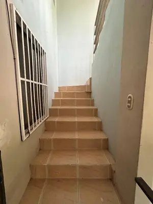 a staircase with wooden steps in a building at Apartamento Quepos in Quepos
