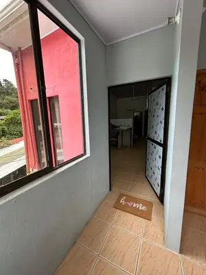 an empty room with a window and a tiled floor at Apartamento Quepos in Quepos