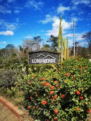 a sign for a landscaping with flowers at Casa Lucas in Villarreal