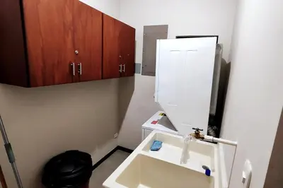 a bathroom with a white sink and wooden cabinets at Casa Lucas in Villarreal