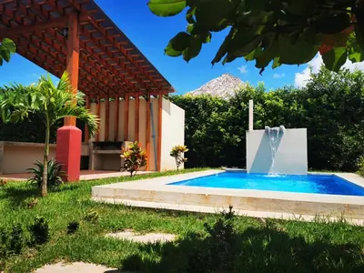 a swimming pool with a fountain in a yard at Casa Lucas in Villarreal