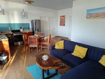a living room with a blue couch and a table at Pronájem prázdninového domu in Tivives
