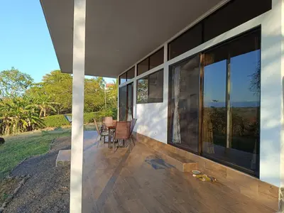 a porch of a house with a table and chairs at Pronájem prázdninového domu in Tivives