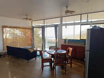 a living room with a table and chairs and a couch at Pronájem prázdninového domu in Tivives