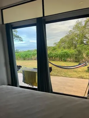 a bedroom with a view of a hammock outside a window at Pronájem prázdninového domu in Tivives