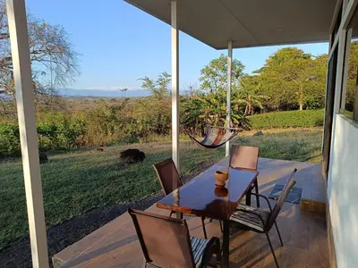 a table and chairs on a porch with a view at Pronájem prázdninového domu in Tivives