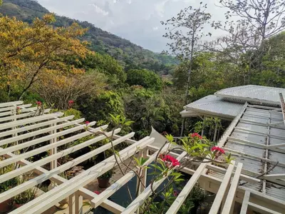 a group of bleachers with flowers and a building at Villa Turrubares in San Pablo