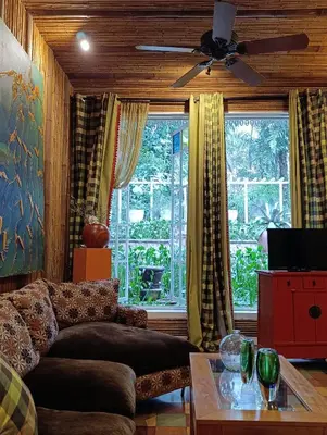a living room with a couch and a large window at Villa Turrubares in San Pablo