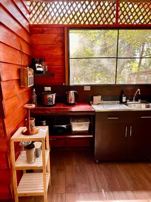 a small kitchen with a sink and a window at Casa LORA Eco nature retreat in Bagaces in Bagaces