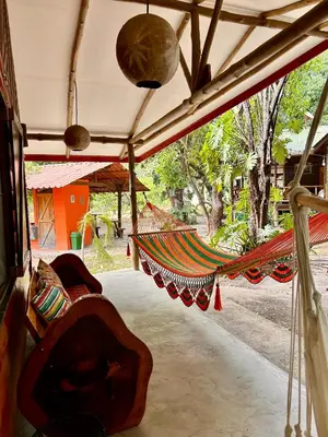 a group of hammocks hanging from a building at Casa LORA Eco nature retreat in Bagaces in Bagaces