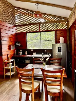 a dining room with a table and chairs in a kitchen at Casa LORA Eco nature retreat in Bagaces in Bagaces