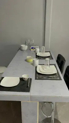 a table with white plates and bowls on it at Roldán Lands in Huacas