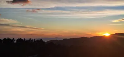 a sunset with the sun setting over the mountains at Mountain & sunset view Villa, Monteverde in Monteverde Costa Rica