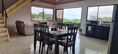 a kitchen and dining room with a table and chairs at Mountain & sunset view Villa, Monteverde in Monteverde Costa Rica