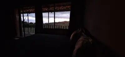a bedroom with a window with a view of a mountain at Mountain & sunset view Villa, Monteverde in Monteverde Costa Rica