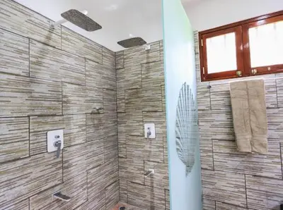 a bathroom with a shower with a glass door at Casa Colibrí Playa Grande in Santa Cruz