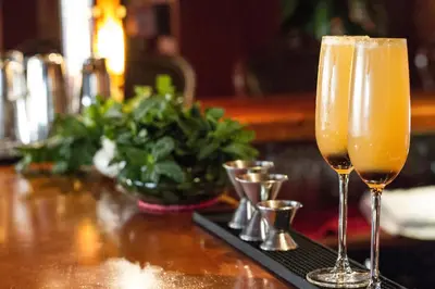 two champagne glasses sitting on a bar with a tray at Hotel Belmar in Monteverde Costa Rica