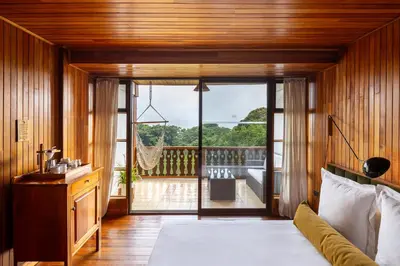 a room with a bed and a view of a balcony at Hotel Belmar in Monteverde Costa Rica