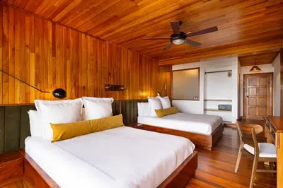 a bedroom with two beds and a ceiling fan at Hotel Belmar in Monteverde Costa Rica