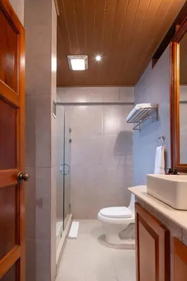 a bathroom with a toilet and a shower and a sink at Hotel Belmar in Monteverde Costa Rica