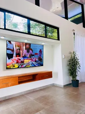 a living room with a flat screen tv on a wall at Casa Nara in Sámara