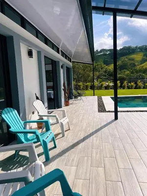 a patio with chairs and a swimming pool at Casa Nara in Sámara