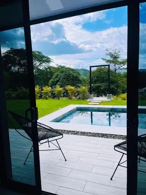 a patio with two chairs and a swimming pool at Casa Nara in Sámara