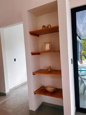 a room with wooden shelves next to a door at Casa Nara in Sámara