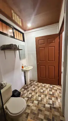 a bathroom with a toilet and a sink at Cabinas Caño Negro in Los Chiles