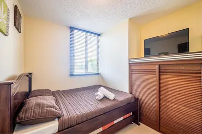 a bedroom with a bed and a flat screen tv at 2-17 Jaco Beach Beautiful Costa Linda Condo in Jacó