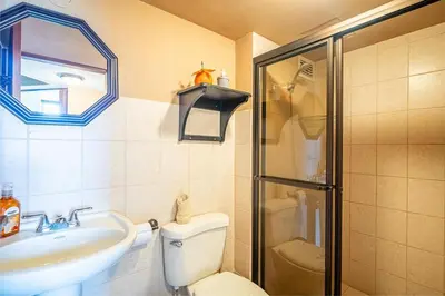 a bathroom with a toilet and a sink and a shower at 2-17 Jaco Beach Beautiful Costa Linda Condo in Jacó