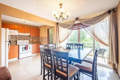 a kitchen and dining room with a table and chairs at 2-17 Jaco Beach Beautiful Costa Linda Condo in Jacó
