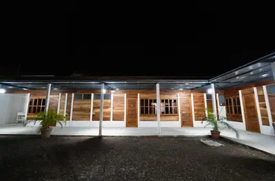 a building with lights in front of it at night at Bay Lodge in La Cruz