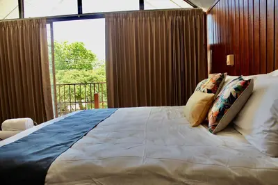a bedroom with a large bed with pillows on it at Villa de Playa, Paseo de los Turistas in Puntarenas