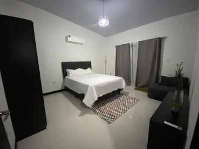 a white bedroom with a bed and a couch at Sarahs Villas in Parrita