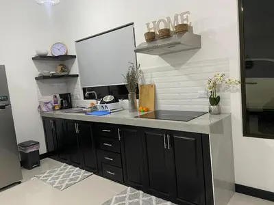 a kitchen counter with a sink and a mirror at Sarahs Villas in Parrita