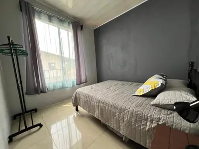 a bedroom with a bed and a window at Bellavista Ceci A2 in San Ramón