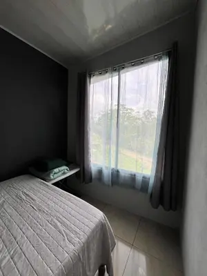 a bedroom with a bed and a large window at Bellavista Ceci A2 in San Ramón