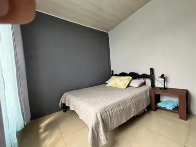 a bedroom with a bed and a side table at Bellavista Ceci A2 in San Ramón