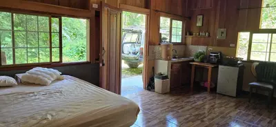 a bedroom with a bed and a kitchen with a van at Cabaña Rio Diamante in San Luis