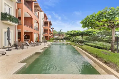 a swimming pool in the middle of a house at HM103 Blissful 2BR Beachfront Condo in Tamarindo
