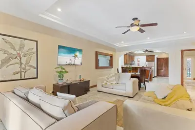 a living room with two couches and a ceiling fan at HM103 Blissful 2BR Beachfront Condo in Tamarindo