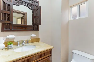 a bathroom with a sink and a mirror at HM103 Blissful 2BR Beachfront Condo in Tamarindo