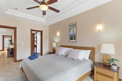 a bedroom with a bed with a ceiling fan at HM103 Blissful 2BR Beachfront Condo in Tamarindo